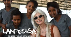 Emmylou Harris poses with young refugees at Adi Harush refugee camp in northern Ethiopia, June 8, 2016. The camp is home to refugees from Eritrea, and a significant percentage of the population are unaccompanied children. (Christian Fuchs — Jesuit Refugee Service/USA)