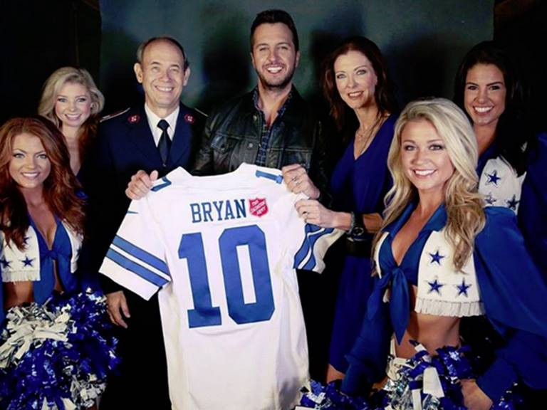 Luke Bryan with the Salvation Army and Dallas Cowboys Cheerleaders