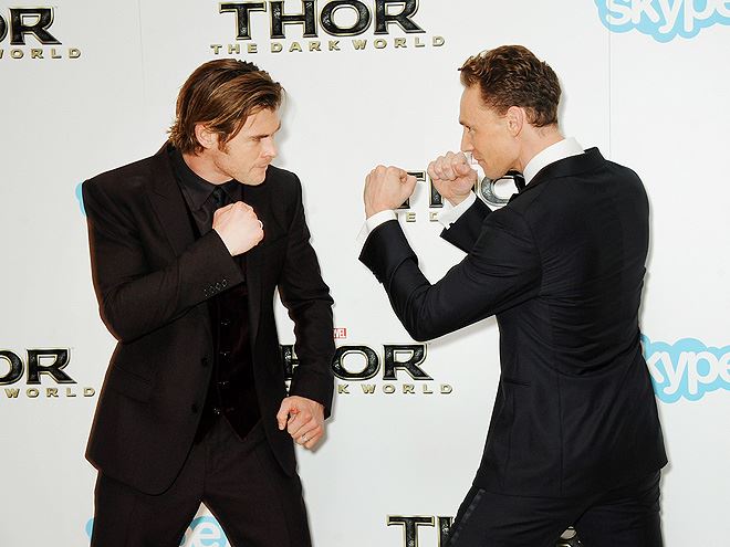 Thor vs. Loki! Chris Hemsworth and Tom Hiddleston play fight at the London opening of their new film. Who would you root for???
