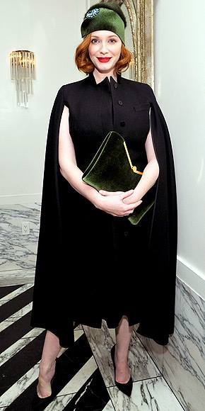 Sultry ‘Mad Men’ actress Christina Hendricks keeps her sweater kittens under control beneath a dark cape. Personally, I like her vintage…